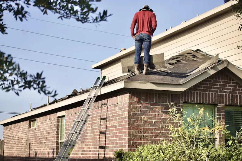 Professional roofer working on a residential roof in Minefield